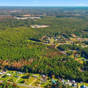 View of property location with a heavily wooded ar