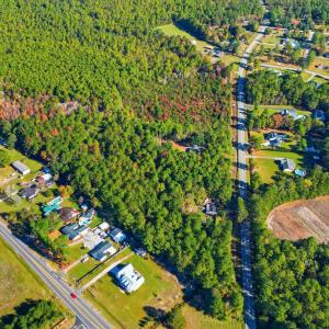 Aerial view of property's location with a forest