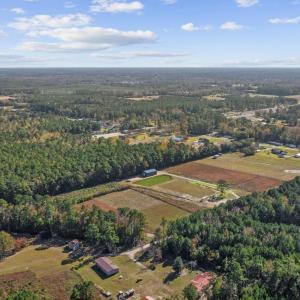View of property location with a heavily wooded ar