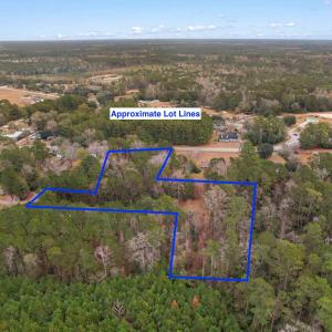 Aerial view of property and surrounding area with