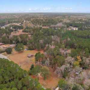 Aerial view of property's location with a forest