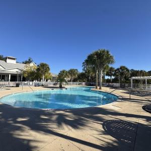 Community pool with a patio and a pergola