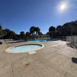 Community pool featuring a patio and a community h