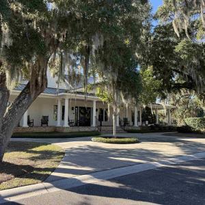 View of front facade featuring a large porch, a me