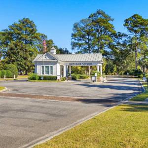 View of asphalt road featuring sidewalks, curbs, a