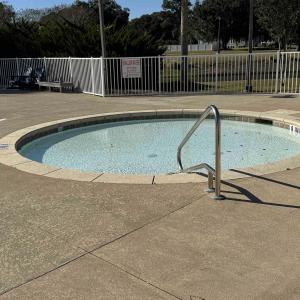 View of pool featuring a hot tub and view of scatt