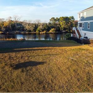 View of yard with stairway and a deck with water v
