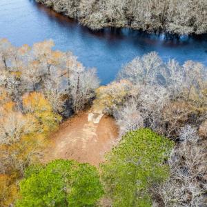Aerial view of a nearby body of water and a heavil