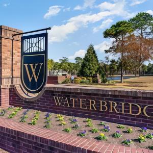 Community sign with a water view