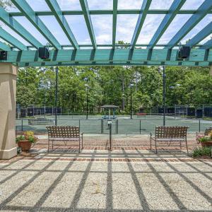 View of patio featuring a pergola and a tennis cou