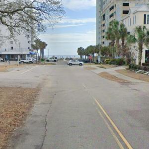 View of asphalt street featuring traffic signs