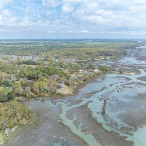 View of property location with a heavily wooded ar