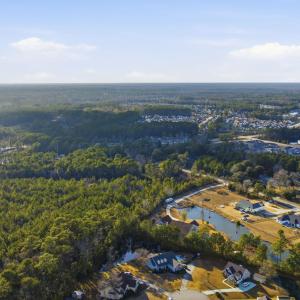View of property location with a heavily wooded ar