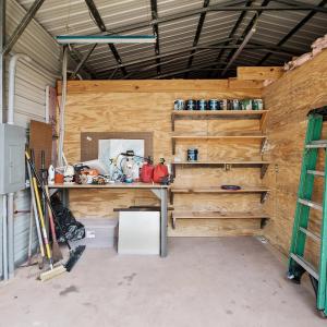 Garage with electric panel and metal wall