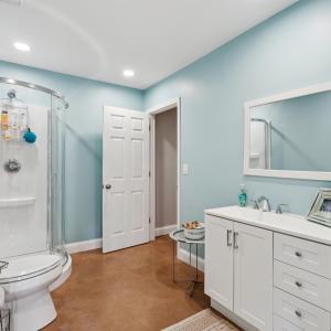 Full bath with finished concrete floors, vanity, a