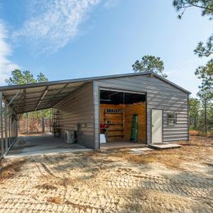 View of outbuilding with a carport