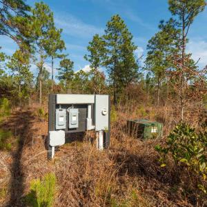 Exterior view of electric meter and a pad mount tr