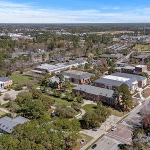 View of property location featuring a tree filled