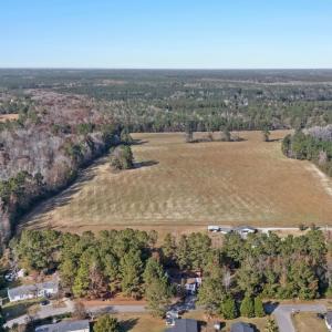 View of property location featuring a forest and r