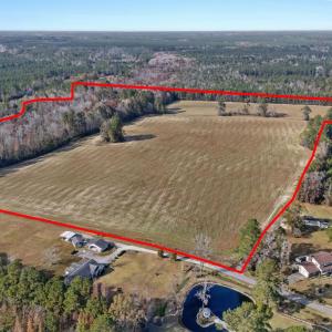 View of property location featuring a forest and p