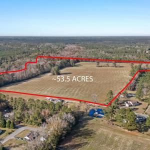 Aerial view of property's location with a forest a