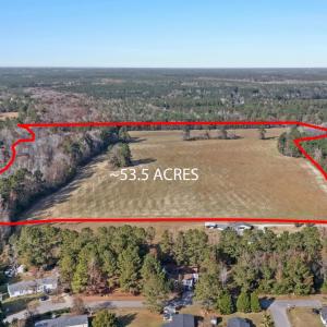 View of property location with a heavily wooded ar