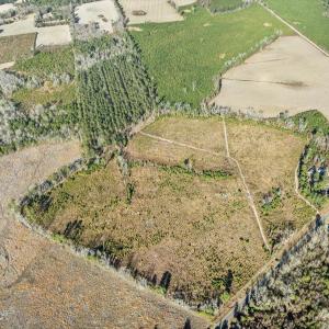 Aerial view of property's location with large plot