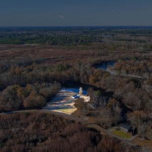 Aerial view of property's location with a forest a