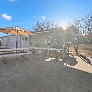 View of patio featuring an outbuilding, a sunroom,