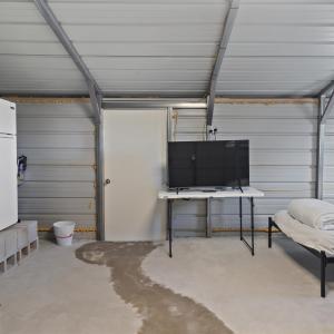 Garage featuring freestanding refrigerator and met