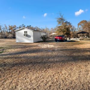 View of the property featuring fencing, a gazebo a