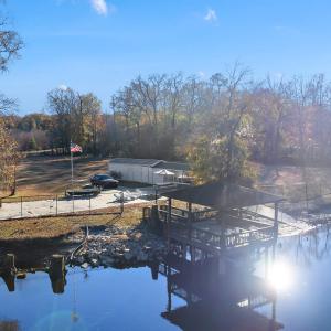 View from the river featuring a gazebo and a boat