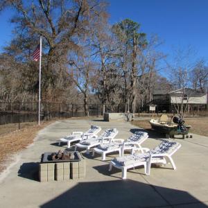 Large concrete patio area with seating and firepit