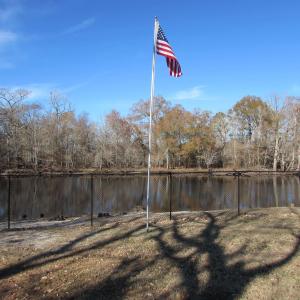View of flagpole and river from the left side lot