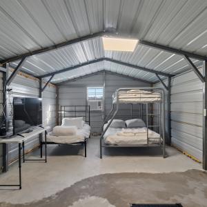 Bunkhouse featuring beds, TV, fridge and Wi-Fi