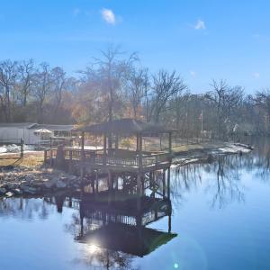 View from the river featuring a gazebo and a boat