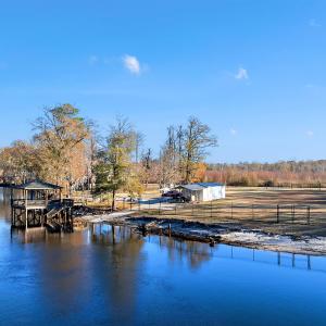 View from the river featuring a gazebo and a boat