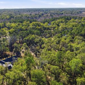 View of property location with a heavily wooded ar