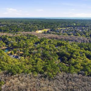 Aerial view of property's location with a forest