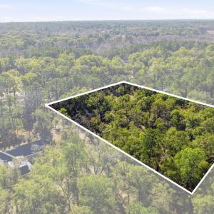 View of property location with a forest and proper