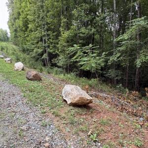 View of landscaping rocks bordering front of lot