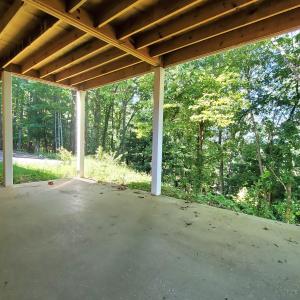 Covered patio overlooks woods