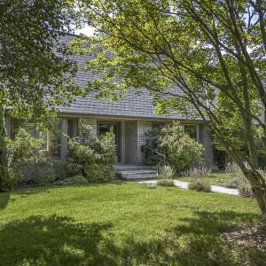 Home viewed from shaded driveway