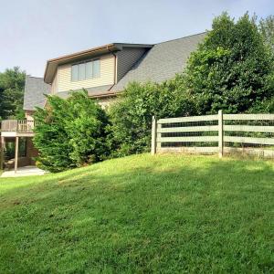 Fenced backyard with garage to right