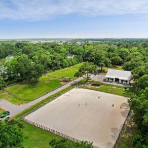 Aerial: paddocks, barn, and arena