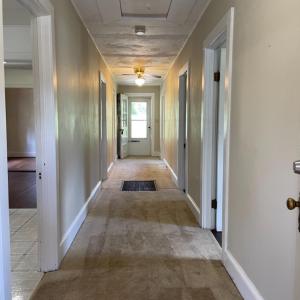 Hallway to bedrooms, sunporch, and laundry room.