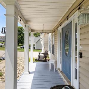 Great front porch to greet neighbors on walks. Fish pond at the end of the porch here.