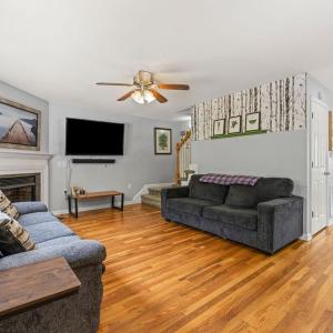 Living Room with gas fireplace. Front door in the background, door to basement on the L of wall, 1/2 bath opposite