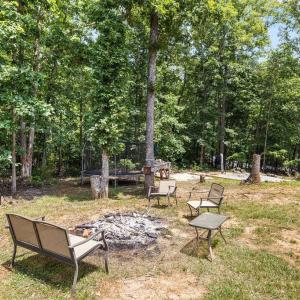 Overlooking the firepit from the deck. the tree stump in the background has towel racks if you choose to replace the above ground pool.