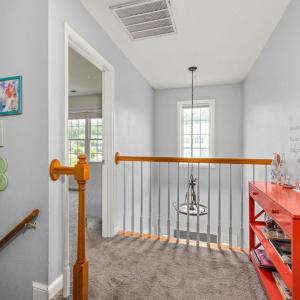 The stairs to go up is on the center wall in the LR; the stairs to go down are stacked under them ~ across from the 1/2 bath. Here we see over the foyer at the front door.